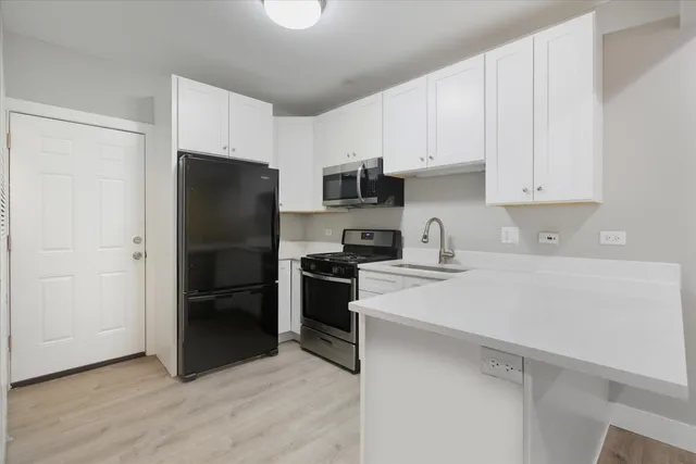 a kitchen with a refrigerator stove and sink