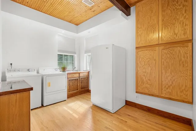 a kitchen with a refrigerator sink stove and wooden floor