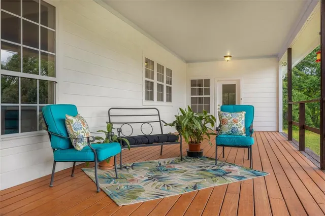 a view of a house with backyard and porch