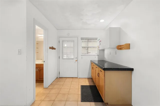 a bathroom with a granite countertop toilet and a sink