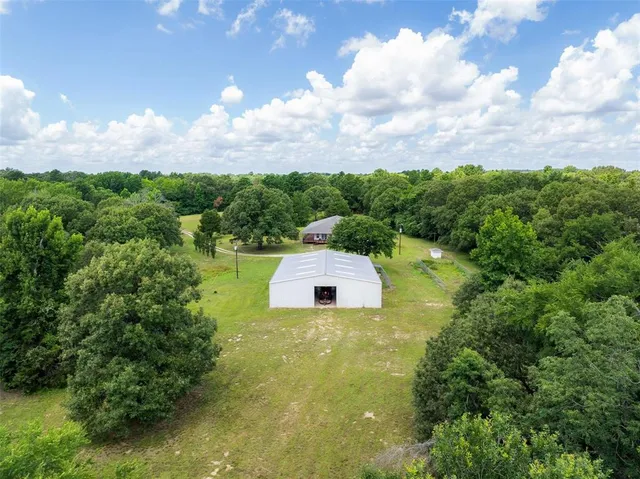 a swimming pool with trees in the background