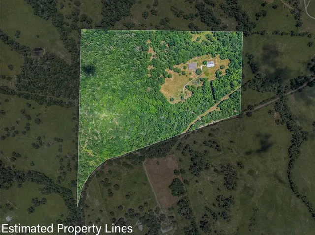 a view of a house with a backyard and a wooden deck