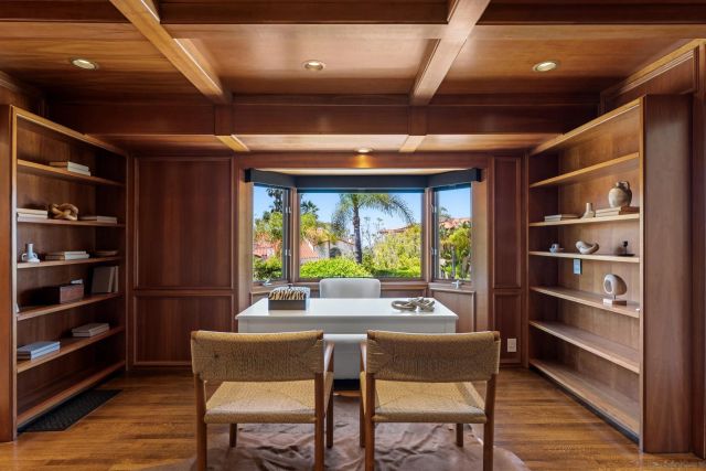 a kitchen with a table chairs refrigerator and a window