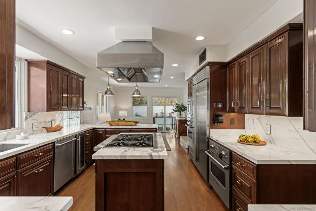 a kitchen with a sink a counter top space and stainless steel appliances