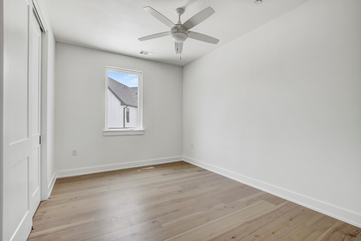 4127 East 12th Street, Unit 5 Austin, TX 78721 - Photo 23 of 33 Empty room with baseboards, light wood-style floors, and ceiling fan