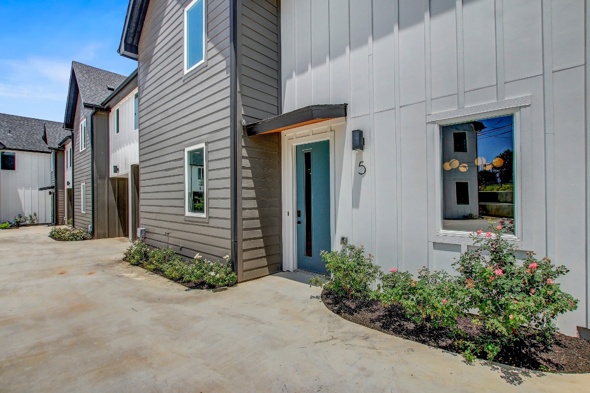 4127 East 12th Street, Unit 5 Austin, TX 78721 - Photo 28 of 33 Doorway to property with board and batten siding and a patio area