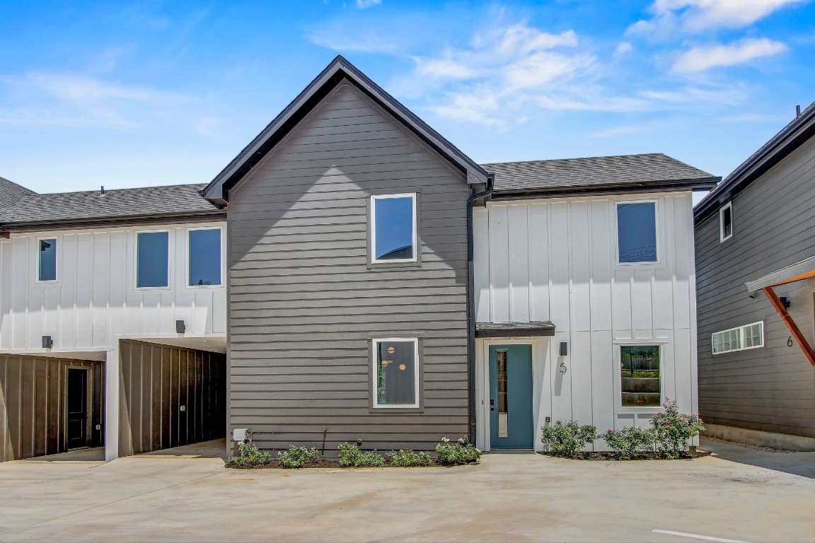 4127 East 12th Street, Unit 5 Austin, TX 78721 - Photo 30 of 33 View of front facade with board and batten siding and roof with shingles