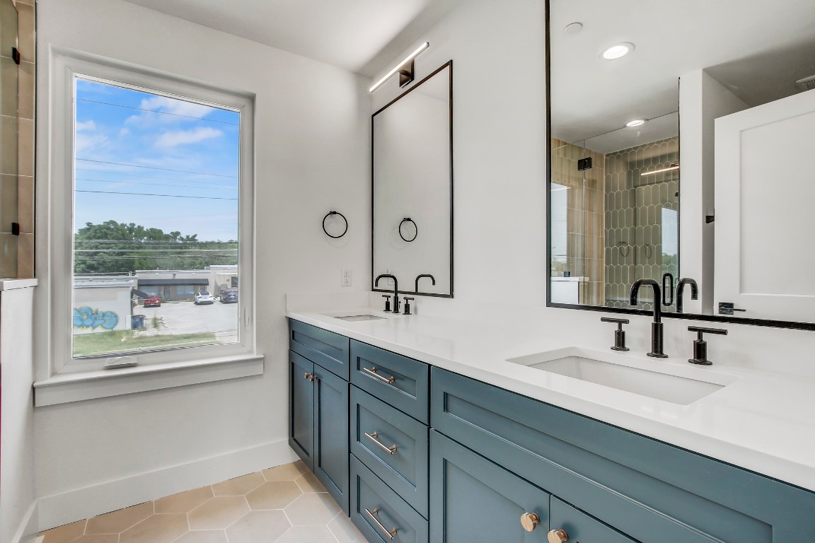 4127 East 12th Street, Unit 5 Austin, TX 78721 - Photo 6 of 33 Bathroom with tile patterned flooring, baseboards, double vanity, recessed lighting, and a tile shower