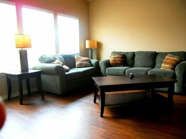 a living room with furniture and a lamp