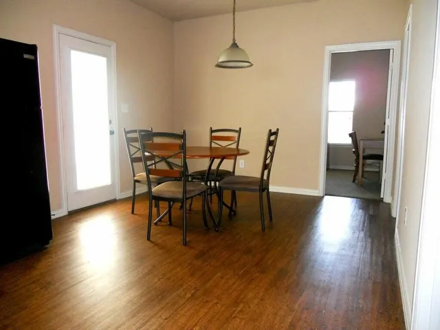 a view of a dining room with furniture and wooden floor