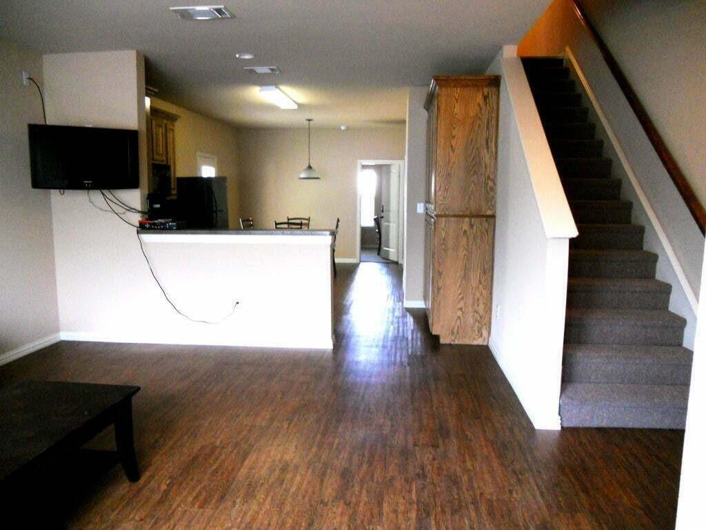 2418 West Prairie Street, Unit 1 Denton, TX 76201 - Photo 4 of 11 an entryway in a hall with a window and wooden floor