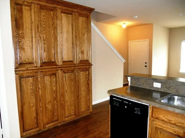 a view of a kitchen counter space and wooden floor