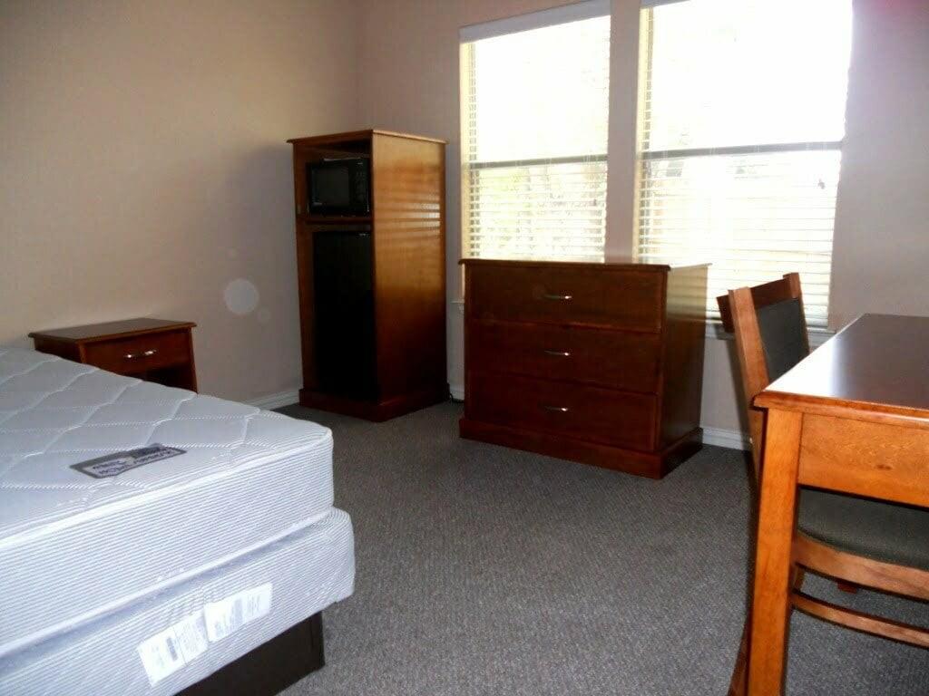 2418 West Prairie Street, Unit 1 Denton, TX 76201 - Photo 7 of 11 a room with a window and a dresser