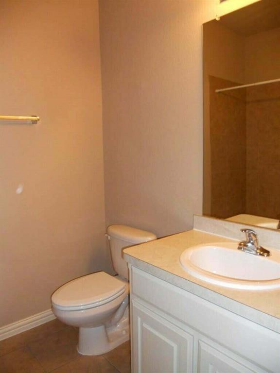2418 West Prairie Street, Unit 1 Denton, TX 76201 - Photo 8 of 11 a bathroom with a sink and a toilet