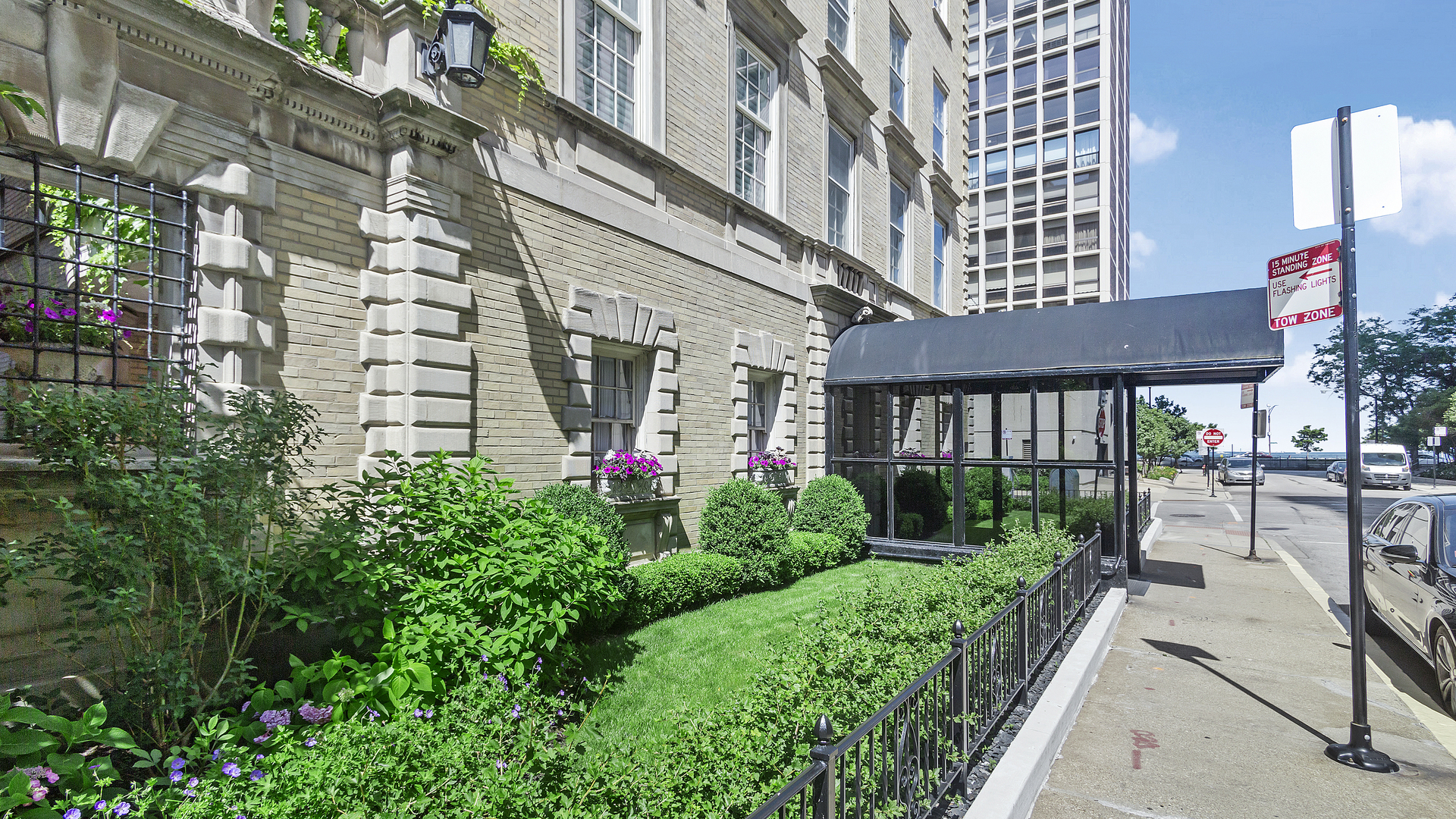 70 East Scott Street, Unit 908 Chicago, IL 60610 - Photo 2 of 15 a front view of a multi story residential apartment building with yard and green space