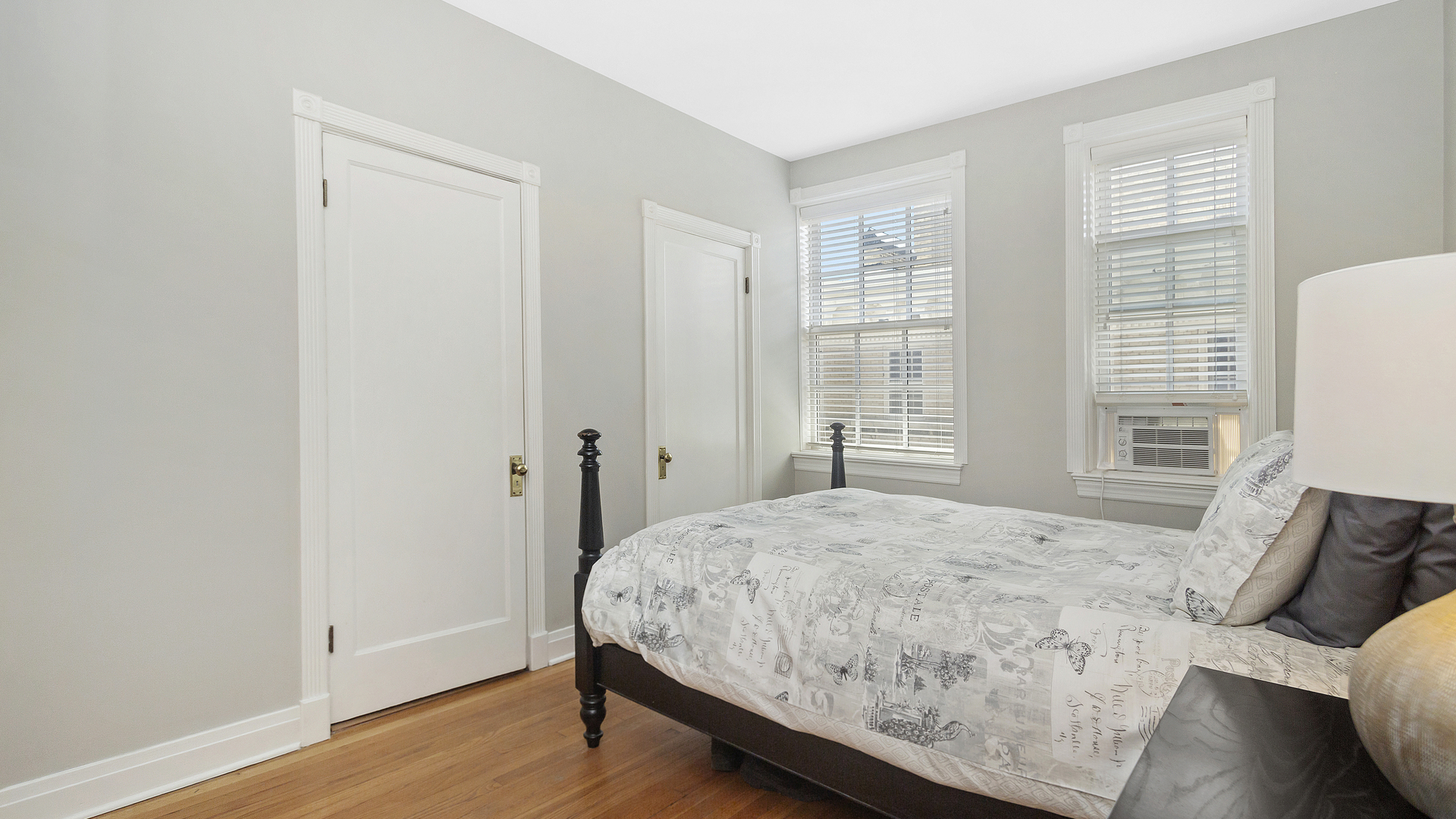 70 East Scott Street, Unit 908 Chicago, IL 60610 - Photo 13 of 15 a bedroom with a bed and wooden floor