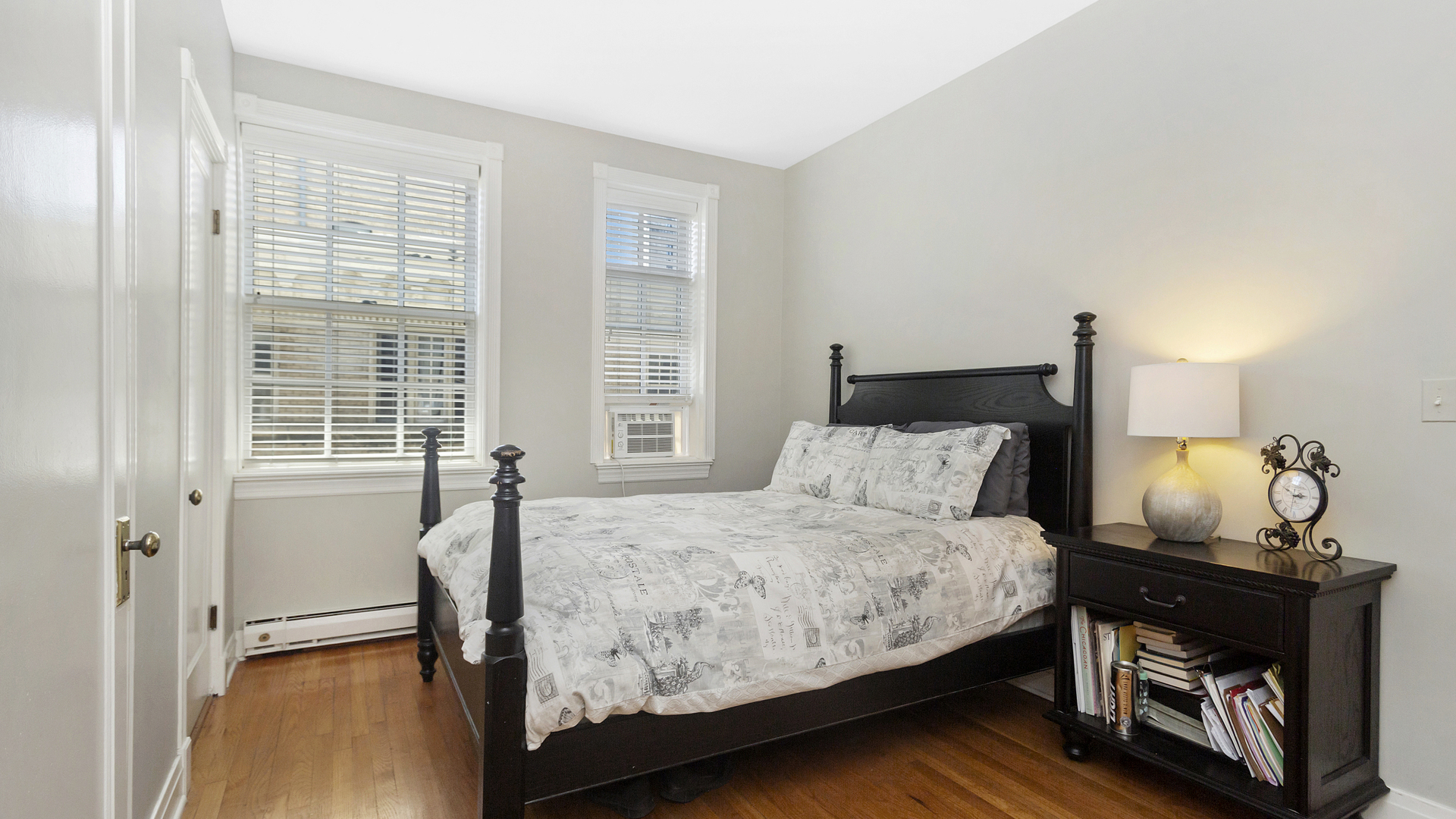 70 East Scott Street, Unit 908 Chicago, IL 60610 - Photo 14 of 15 a bedroom with a bed and wooden floor