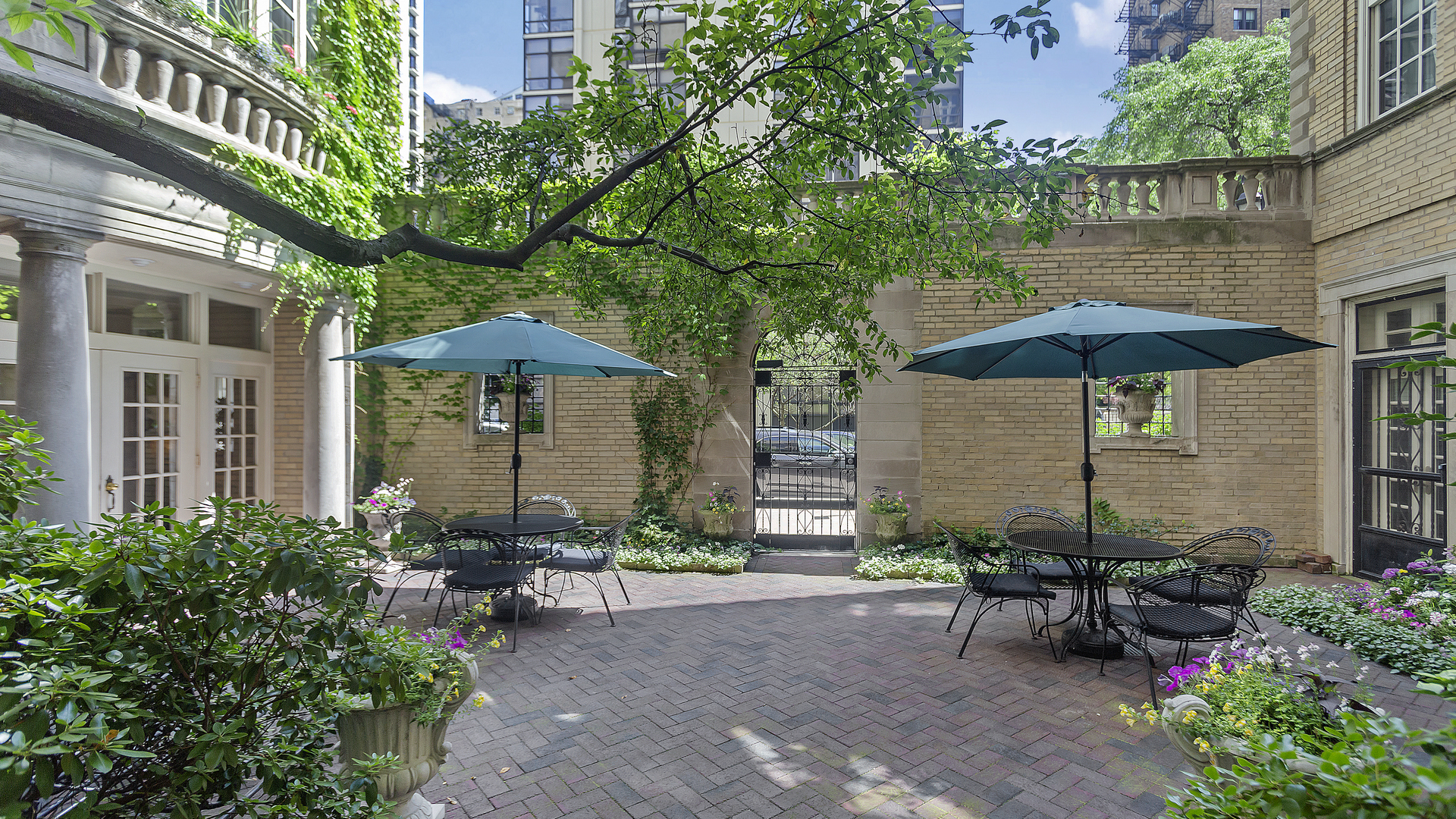 70 East Scott Street, Unit 908 Chicago, IL 60610 - Photo 4 of 15 a view of a table and chairs under an umbrella in the patio
