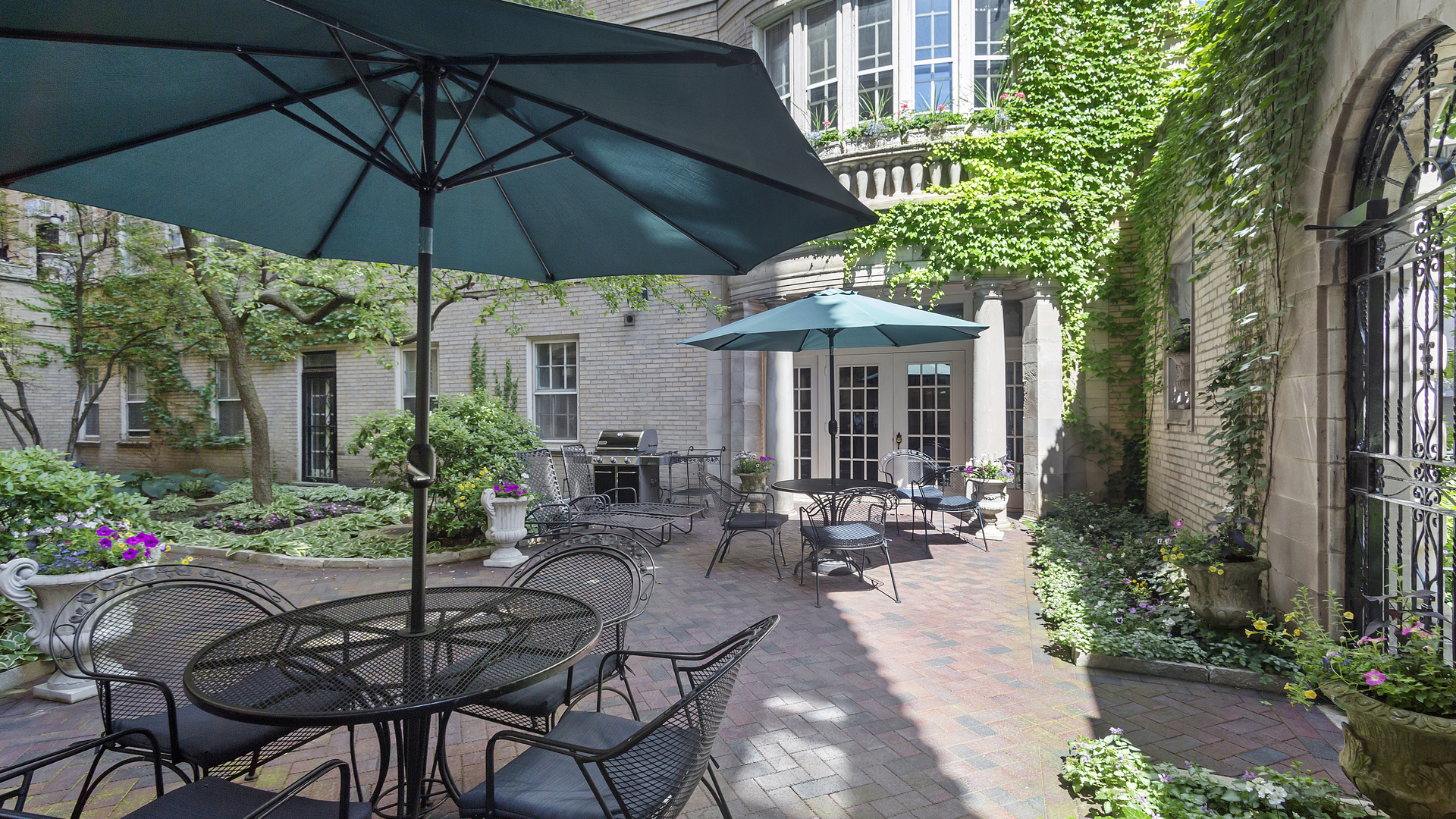 70 East Scott Street, Unit 908 Chicago, IL 60610 - Photo 5 of 15 a view of patio with chairs and table under an umbrella