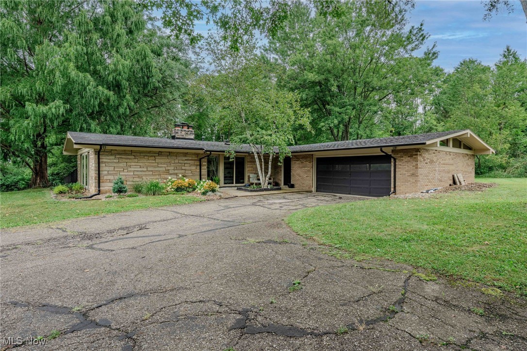 3381 Barrett Road Akron, OH 44333 - Photo 42 of 50 Mid-century home with driveway, a front yard, a garage, and a chimney