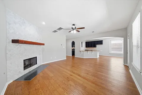 a view of an empty room with a fireplace and a window