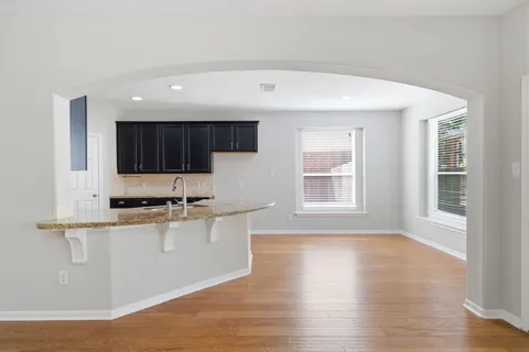 a kitchen with stainless steel appliances granite countertop a stove a sink and a microwave