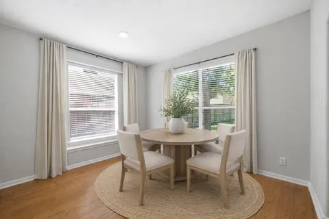 a dining room with furniture and window