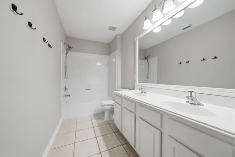 an empty room with closet and windows