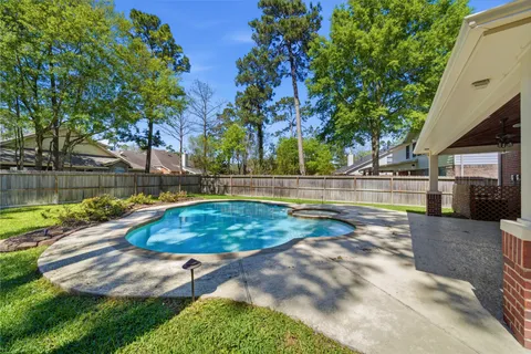 a view of a house with a backyard and a tree