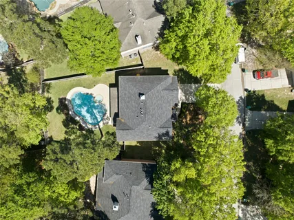 an aerial view of a house with a yard