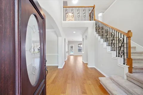 a view of entryway and hall with wooden floor