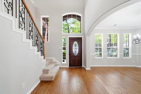 a view of entryway and hall with wooden floor