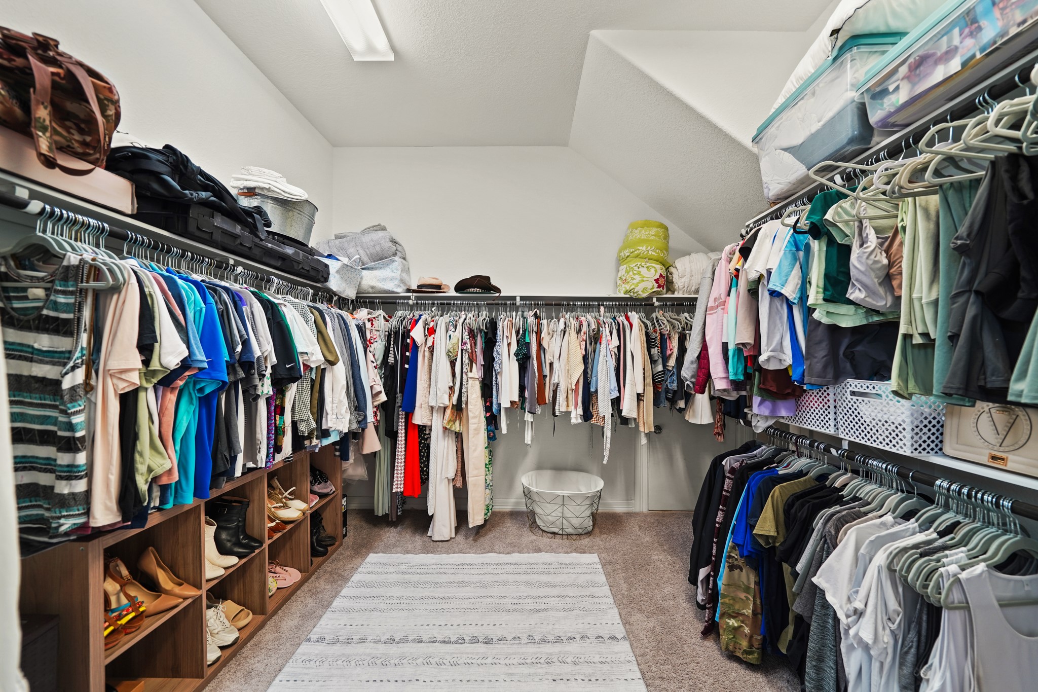 24031 Corinaldo Court Katy, TX 77493 - Photo 13 of 23 a view of walk in closet with clothes and shoes