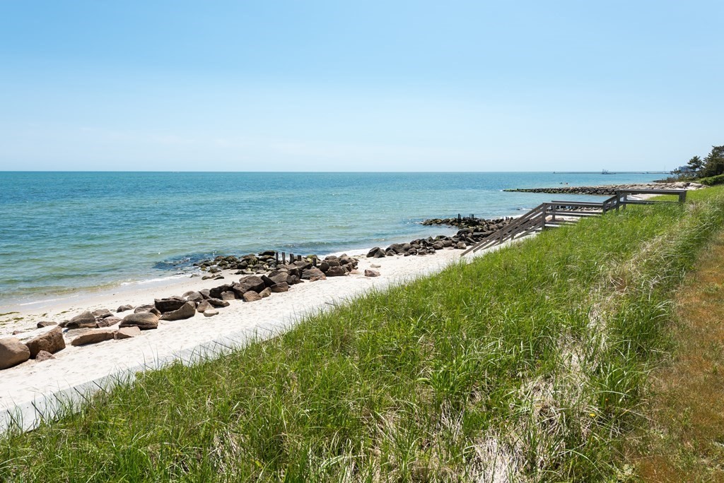 29 Walther Road Harwich, MA 02646 - Photo 3 of 8 a view of a large body of water with a building in the background