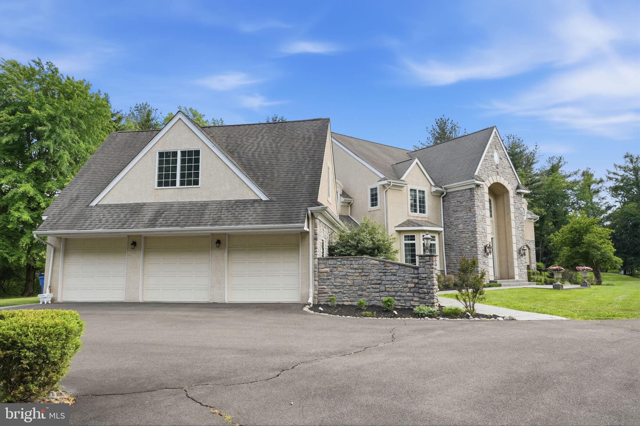 1588 Wrightstown Road Newtown, PA 18940 - Photo 5 of 81 a front view of a house with a yard and garage