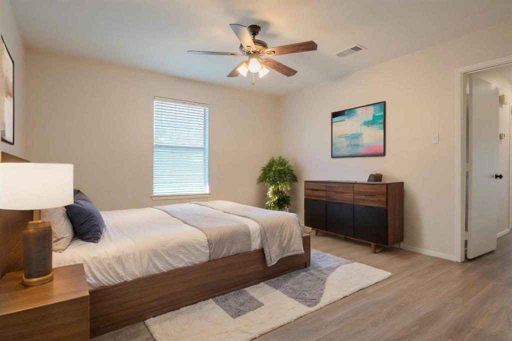 527 Crowley Road Arlington, TX 76012 - Photo 13 of 20 a bedroom with a bed wall painting and a window
