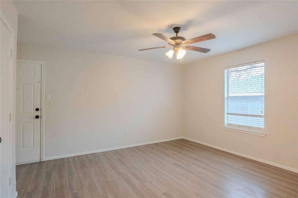 527 Crowley Road Arlington, TX 76012 - Photo 14 of 20 wooden floor in an empty room with a window
