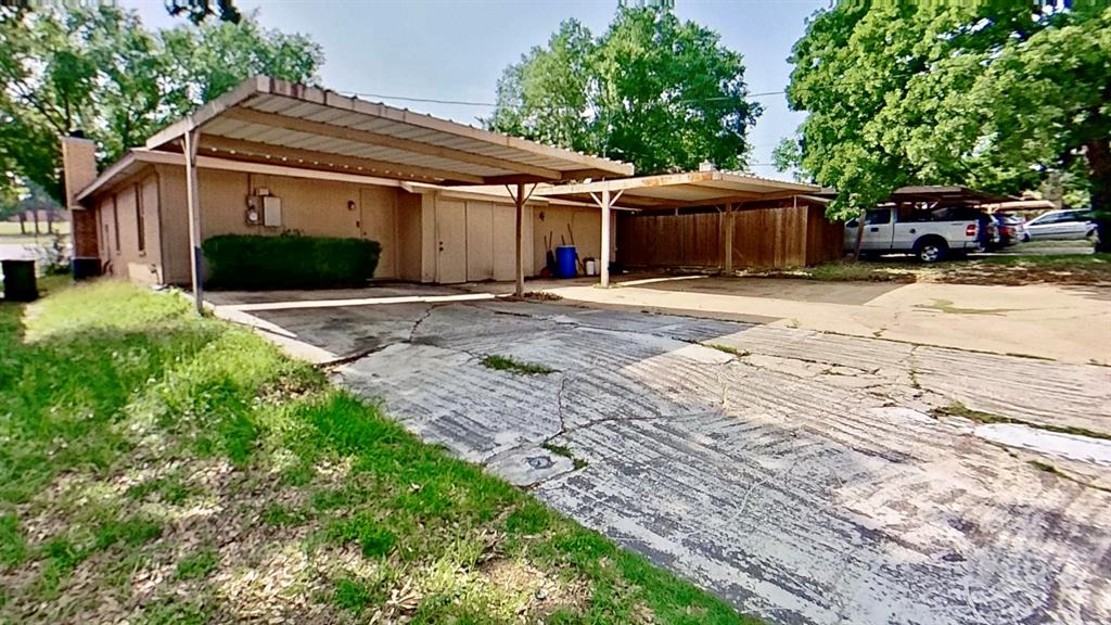 527 Crowley Road Arlington, TX 76012 - Photo 19 of 20 a front view of a house with a garden and trees