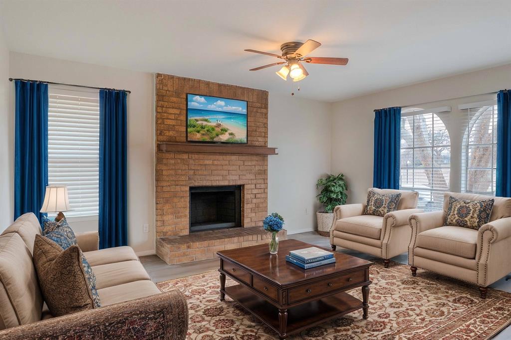 527 Crowley Road Arlington, TX 76012 - Photo 7 of 20 a living room with furniture a flat screen tv and a fireplace