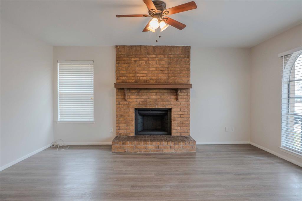 527 Crowley Road Arlington, TX 76012 - Photo 10 of 20 a living room with a fireplace and wooden floor