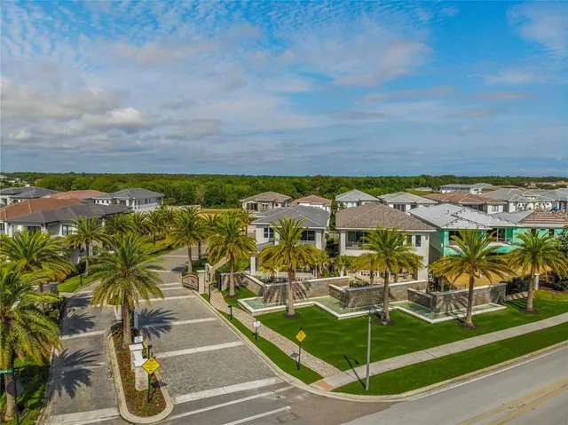 an aerial view of residential houses with outdoor space and parking
