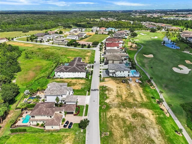 an aerial view of a house with a yard basket ball court and outdoor seating