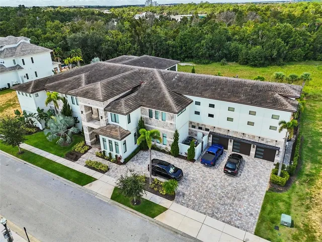 an aerial view of a house with big yard