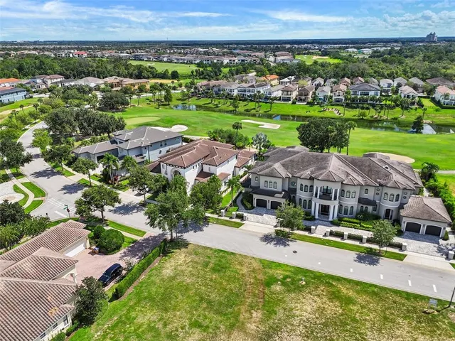 an aerial view of a house with big yard