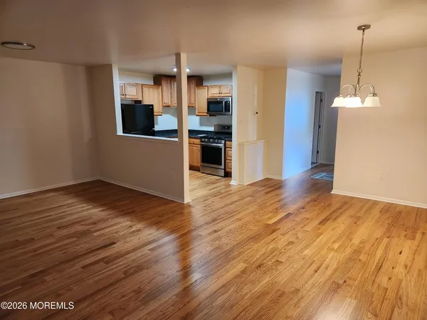 a view of a kitchen with wooden floor and a kitchen