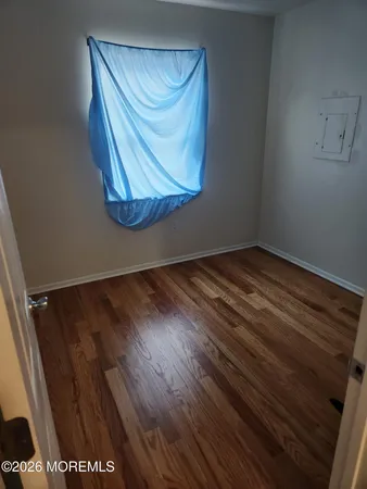 a view of a bench in wooden floor