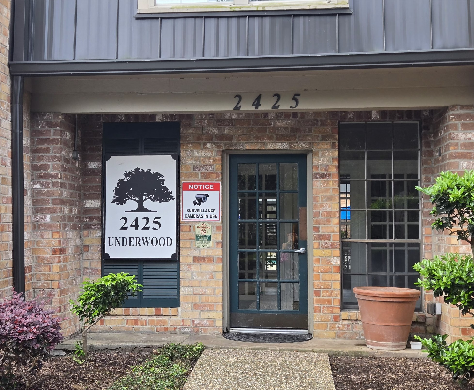 2425 Underwood Street, Unit 355 Houston, TX 77030 - Photo 1 of 17 a front view of a house with a potted plant and a bench
