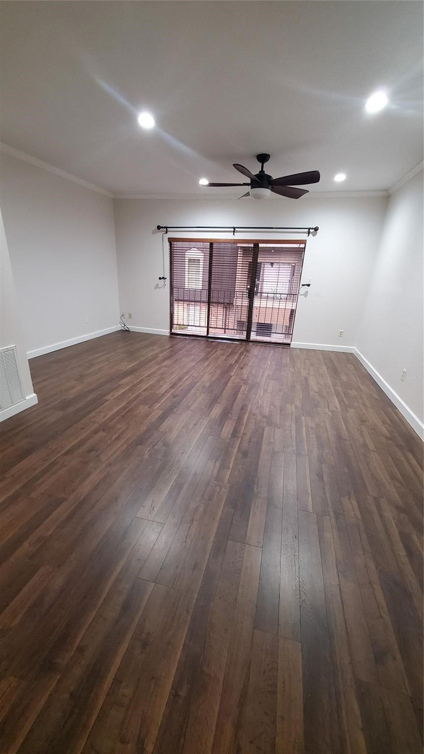 2425 Underwood Street, Unit 355 Houston, TX 77030 - Photo 4 of 17 a view of empty room with wooden floor and ceiling fan
