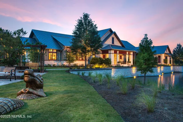 a view of a house with pool and a yard