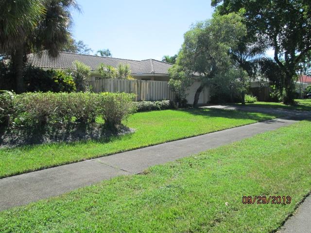 1236 Northwest 16th Street Boca Raton, FL 33486 - Photo 17 of 17 a view of a garden with a building in the background
